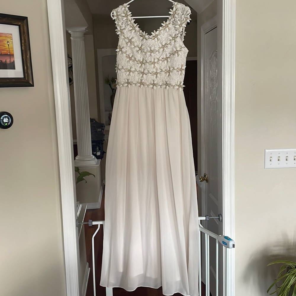 Off white maxi dress with flower lace detail and touches of gold in flowers